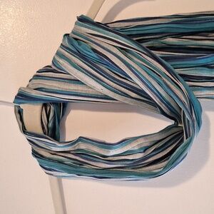 Decorative scarf in shades of blue with silver accent and fringe